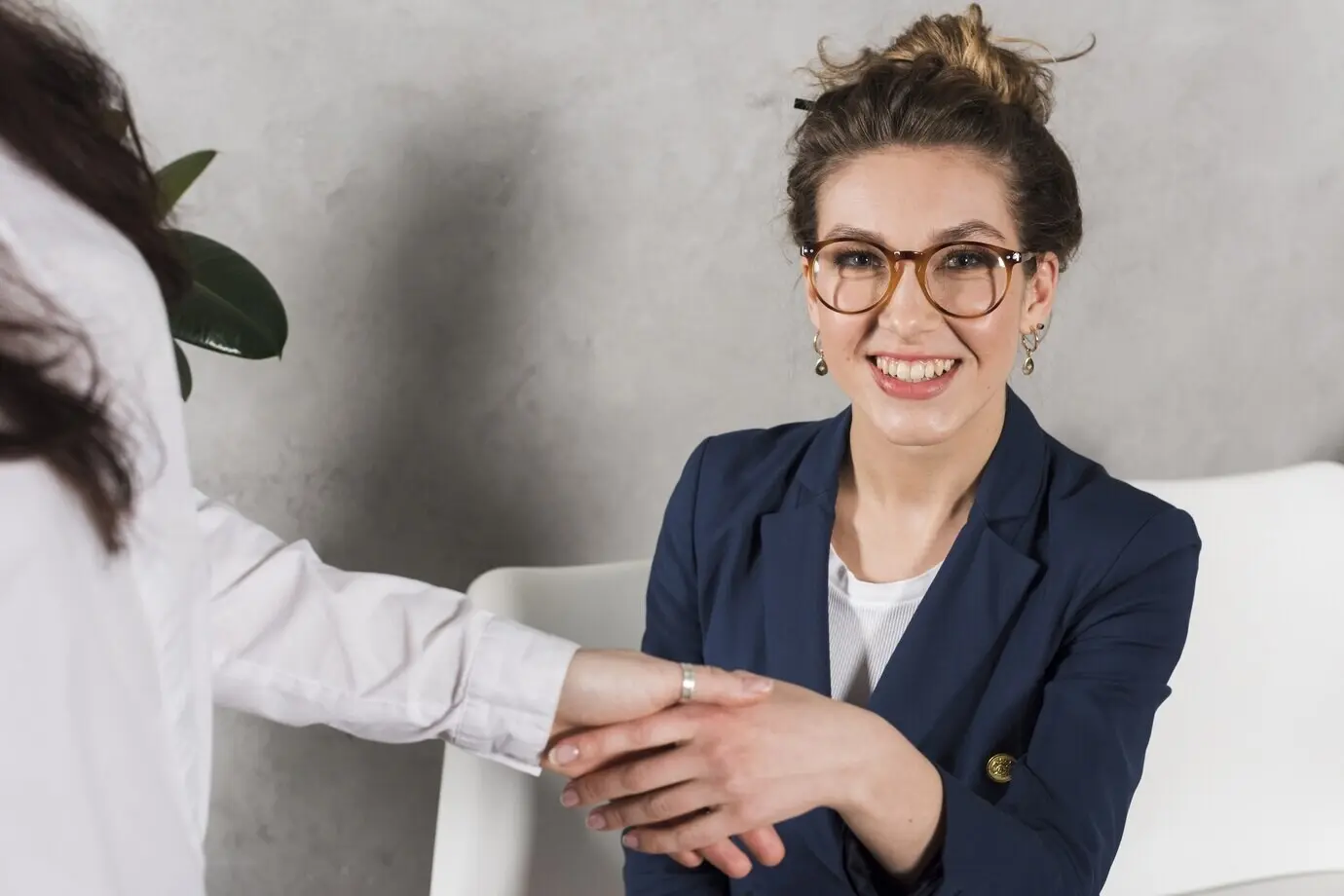 Front view of a woman's hand shaking with a human resources person